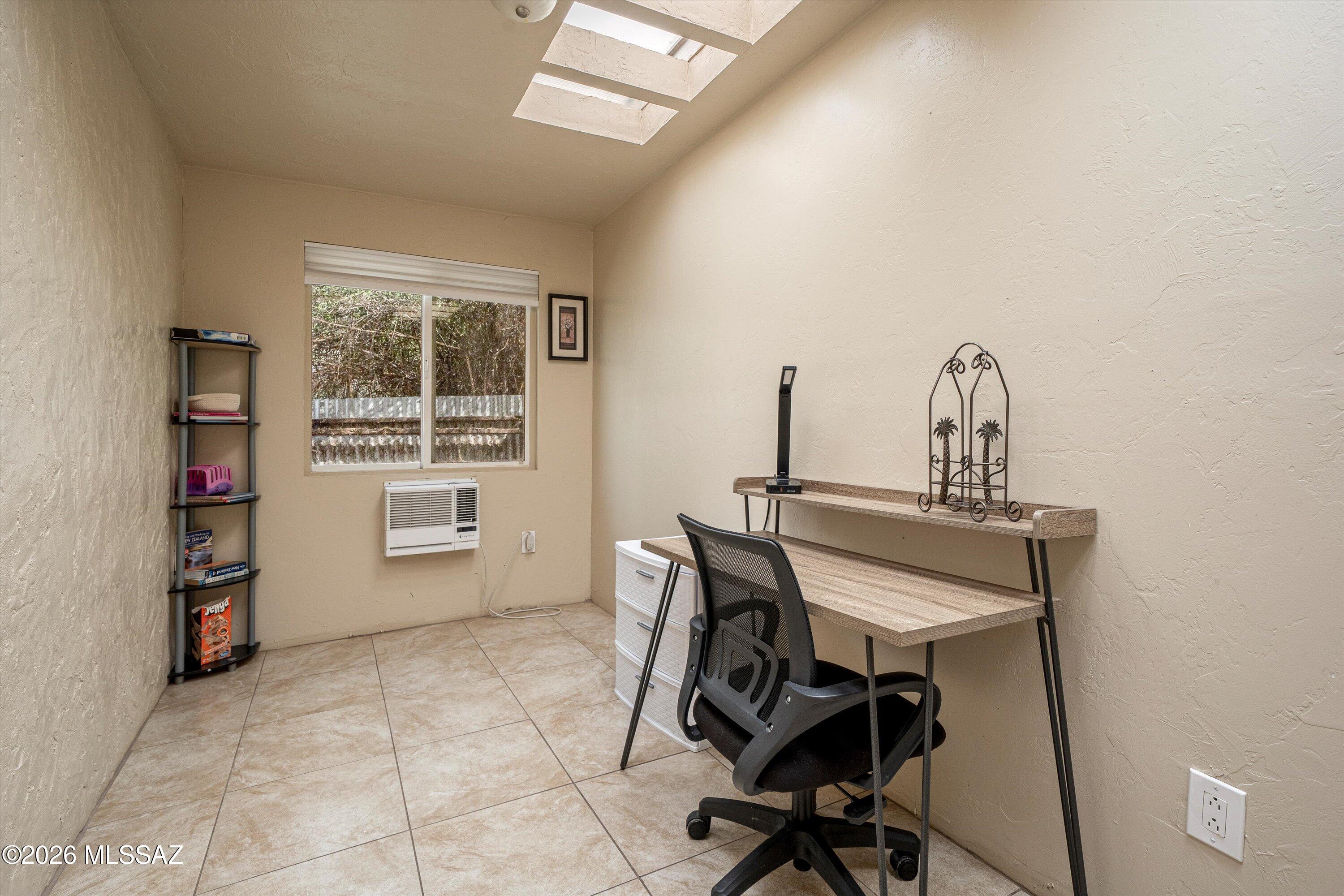 2619 East Prince Road Tucson, AZ 85716 - Photo 47 of 50 a view of a workspace with furniture and a window
