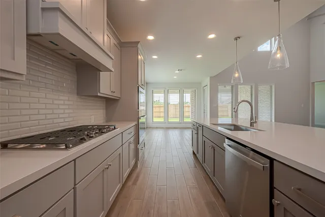 a kitchen with granite countertop a stove and a sink