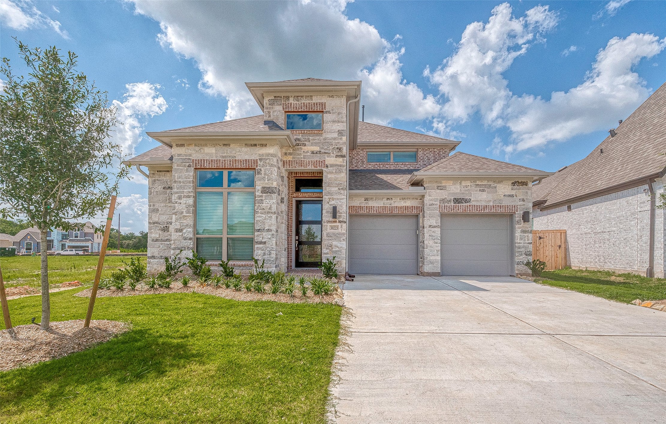 30223 GOLD FINCH Place Fulshear, TX 77441 - Photo 2 of 45 a view of a house with a big yard and large tree