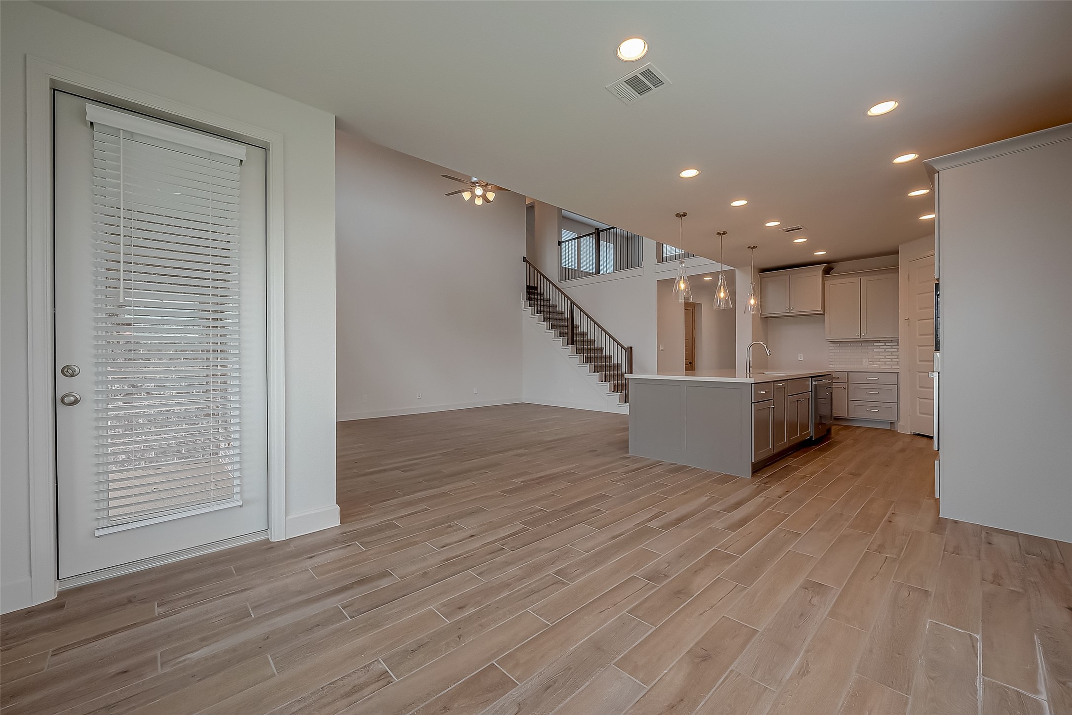 30223 GOLD FINCH Place Fulshear, TX 77441 - Photo 21 of 45 a view of a livingroom with wooden floor and stairs