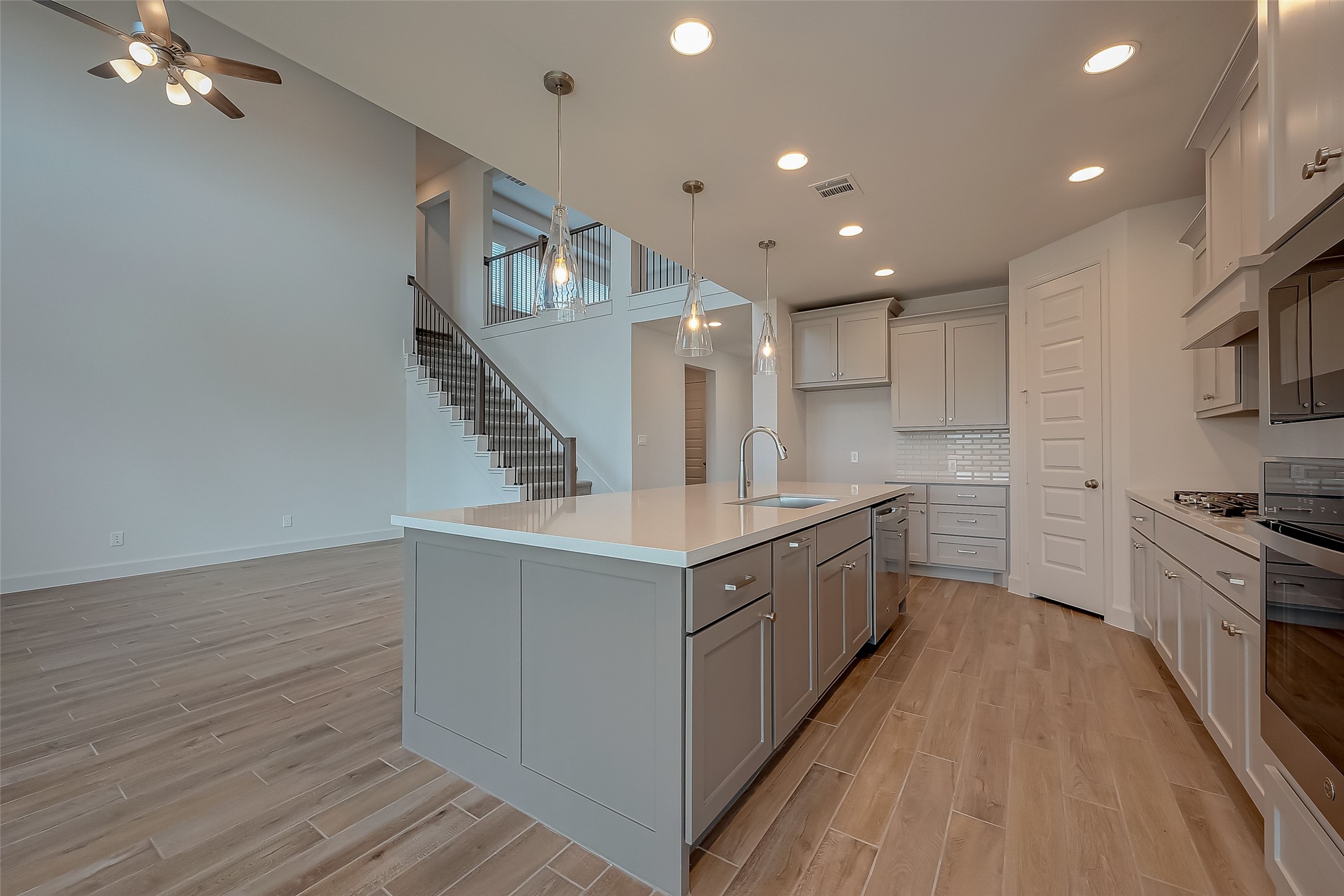 30223 GOLD FINCH Place Fulshear, TX 77441 - Photo 22 of 45 a large kitchen with stainless steel appliances granite countertop a lot of counter space and wooden floors