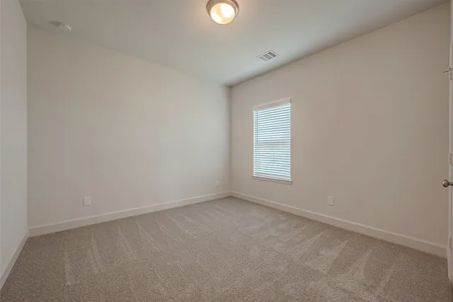 an empty room with windows and with windows