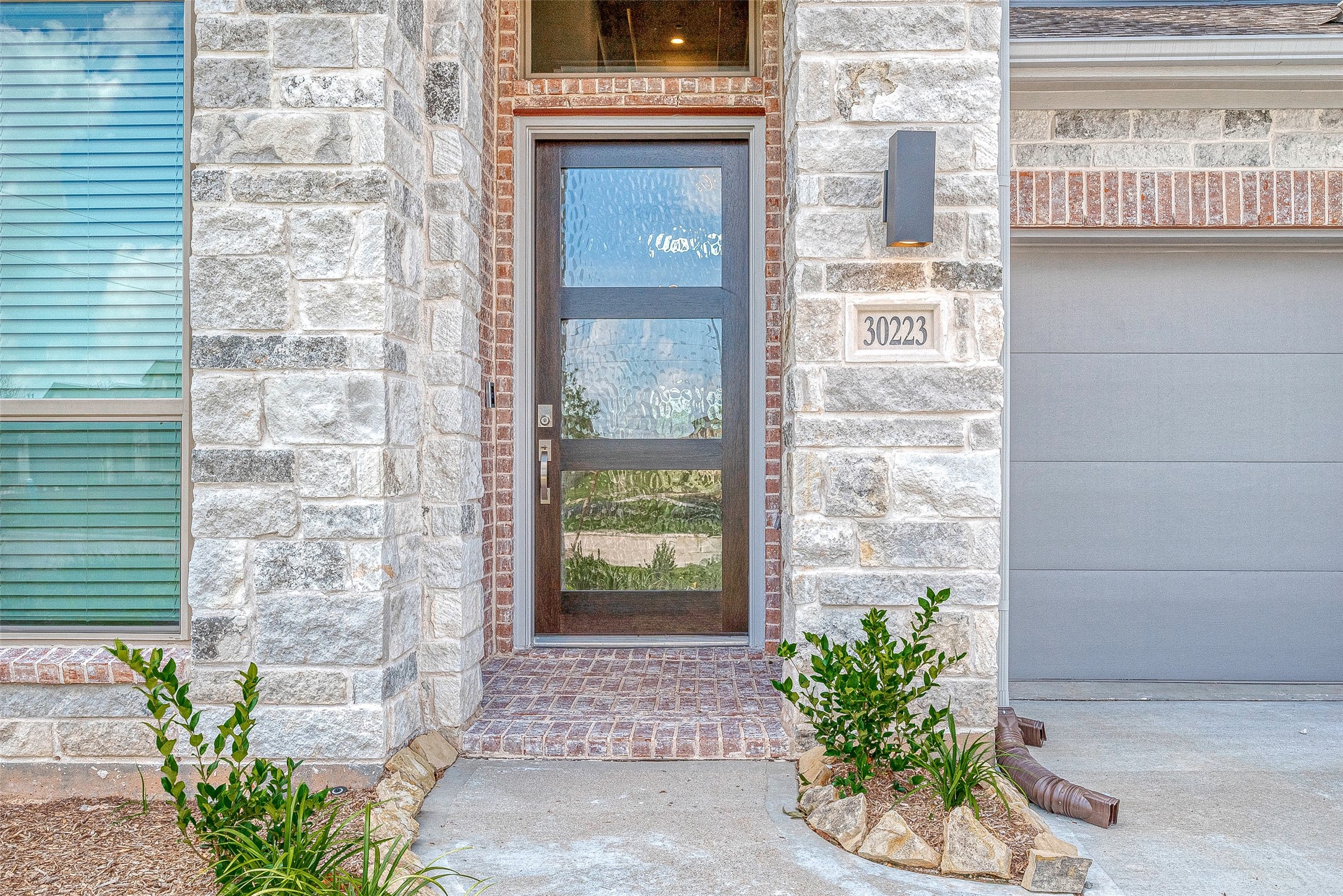30223 GOLD FINCH Place Fulshear, TX 77441 - Photo 3 of 45 a front view of a house with a garden