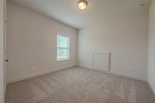 an empty room with windows and closet