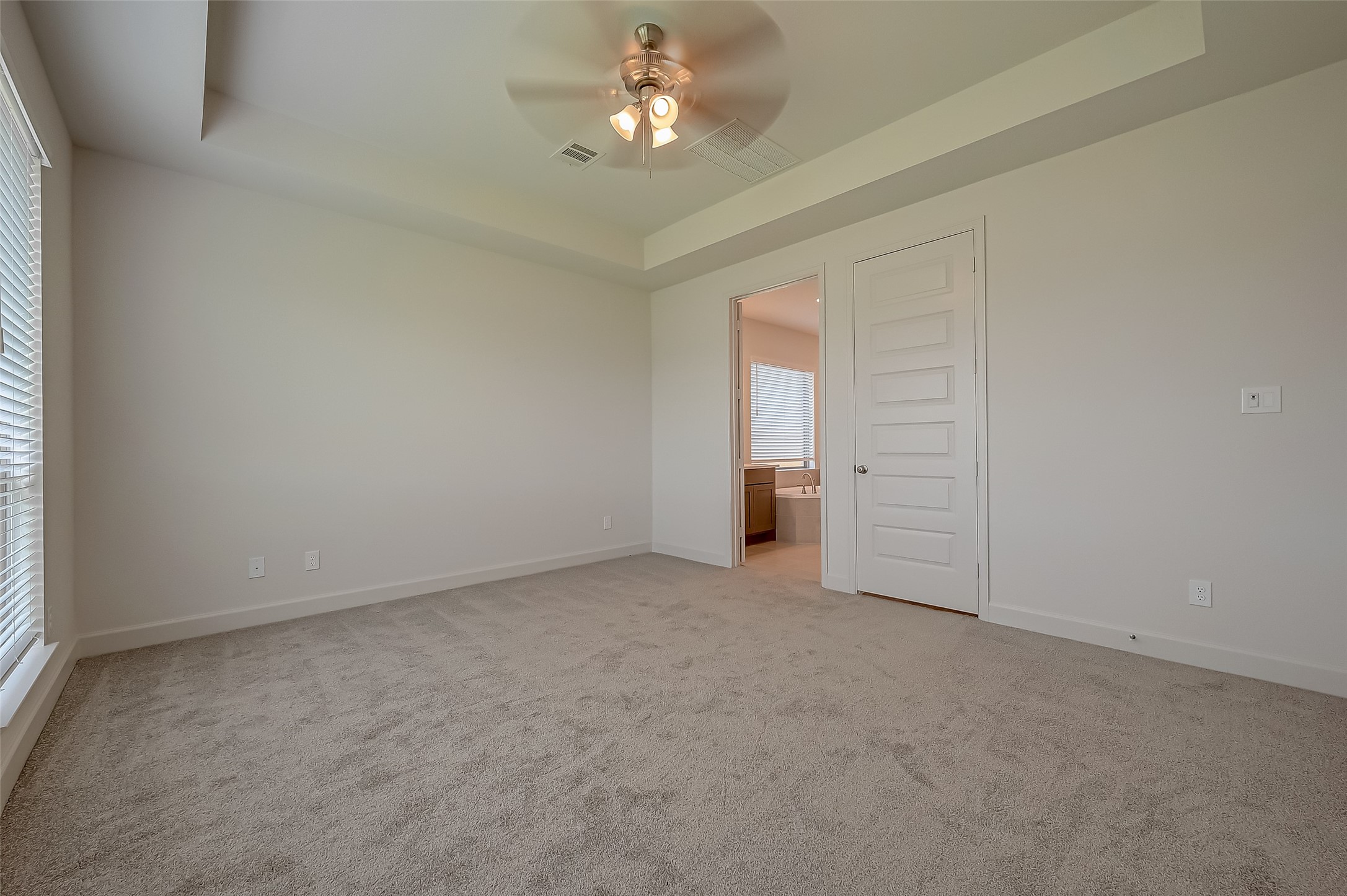 30223 GOLD FINCH Place Fulshear, TX 77441 - Photo 34 of 45 an empty room with chandelier fan and windows