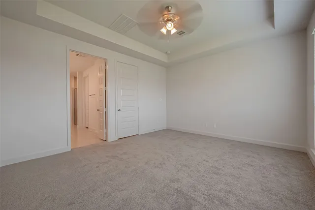 a view of empty room with a chandelier fan