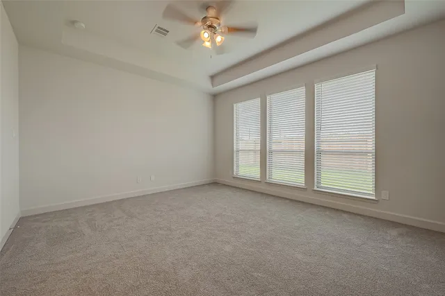 an empty room with a empty space and a ceiling fan
