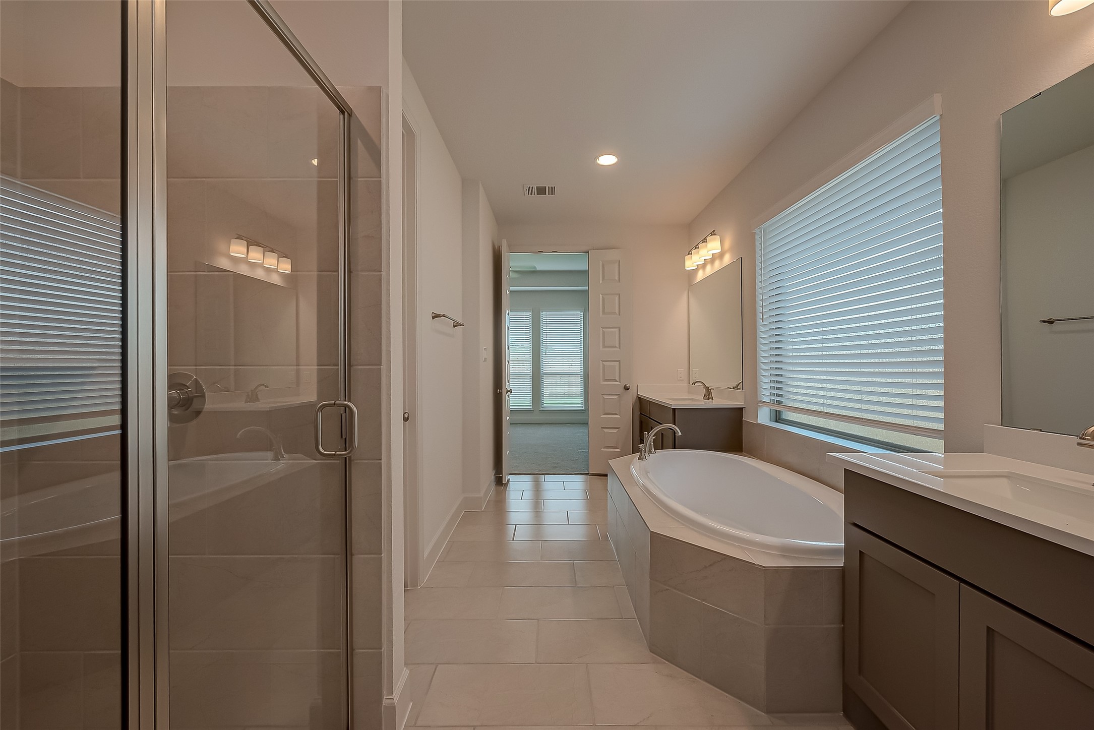 30223 GOLD FINCH Place Fulshear, TX 77441 - Photo 39 of 45 a bathroom with a tub sink and mirror