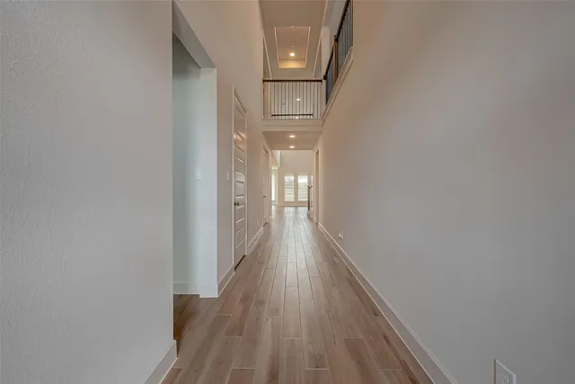 a view of a hallway with wooden floor