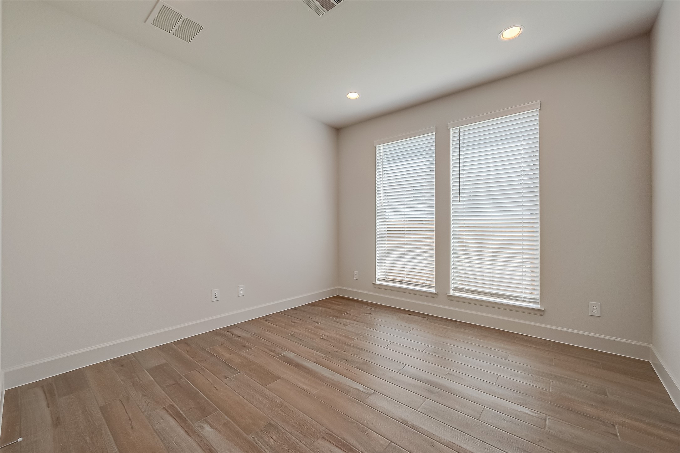 30223 GOLD FINCH Place Fulshear, TX 77441 - Photo 10 of 45 an empty room with wooden floor and windows