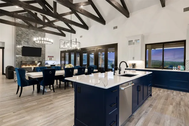 a large kitchen with kitchen island a sink and a table