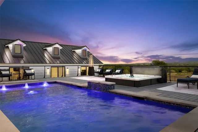 a view of house with swimming pool yard fire pit and outdoor seating