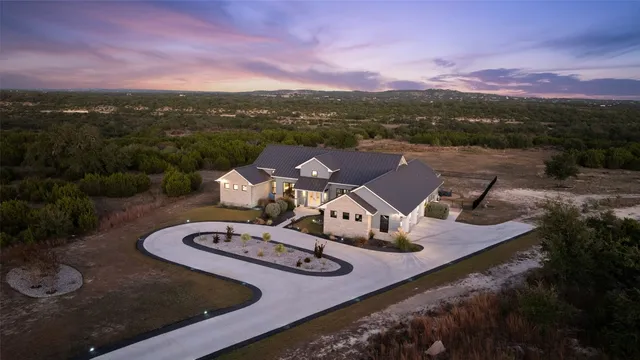 a view of a house with yard and mountain view