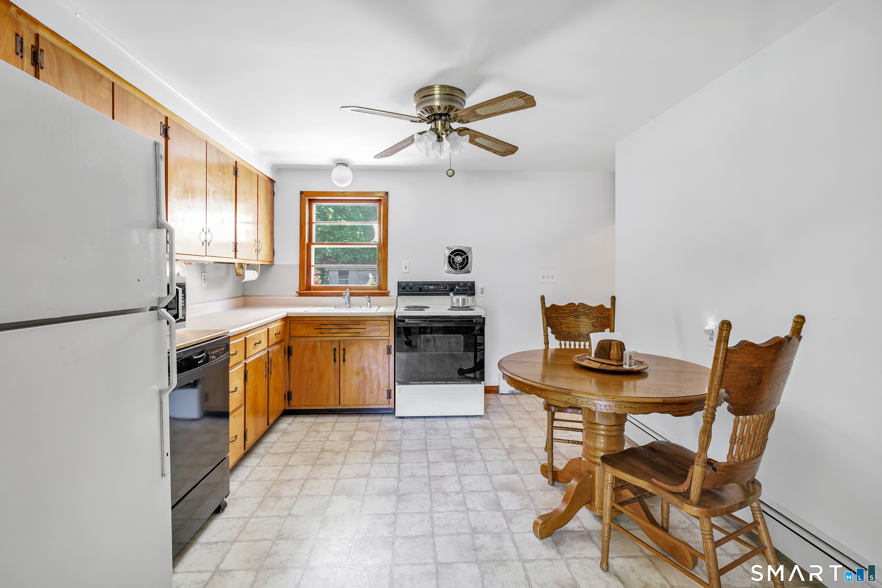 223 Wheeler Road Monroe, CT 06468 - Photo 10 of 35 a kitchen with a table chairs and a refrigerator