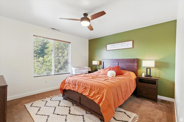 1187 Seraphim Court Layton, UT 84041 - Photo 7 of 18 Carpeted bedroom featuring baseboards and ceiling fan