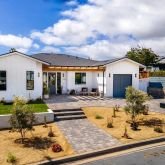 a view of a house with backyard porch and sitting area