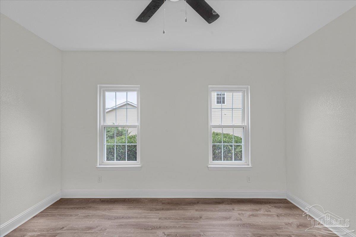 601 East Burgess Road, Unit C3 Pensacola, FL 32504 - Photo 23 of 35 an empty room with windows and chandelier fan