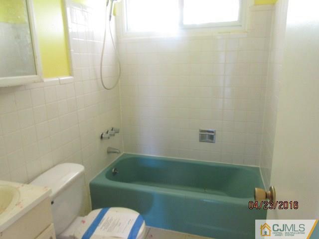 28 Raleigh Road Kendall Park, NJ 08824 - Photo 13 of 16 a bathroom with a sink and a toilet
