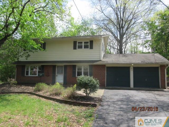 28 Raleigh Road Kendall Park, NJ 08824 - Photo 3 of 16 a front view of a house with a garden and yard