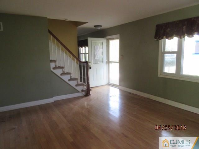 28 Raleigh Road Kendall Park, NJ 08824 - Photo 6 of 16 a view of an empty room with wooden floor and a window