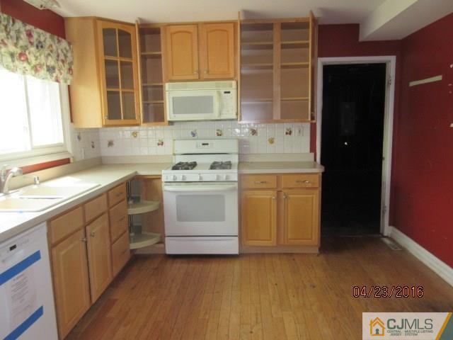 28 Raleigh Road Kendall Park, NJ 08824 - Photo 8 of 16 a kitchen with a stove oven and sink