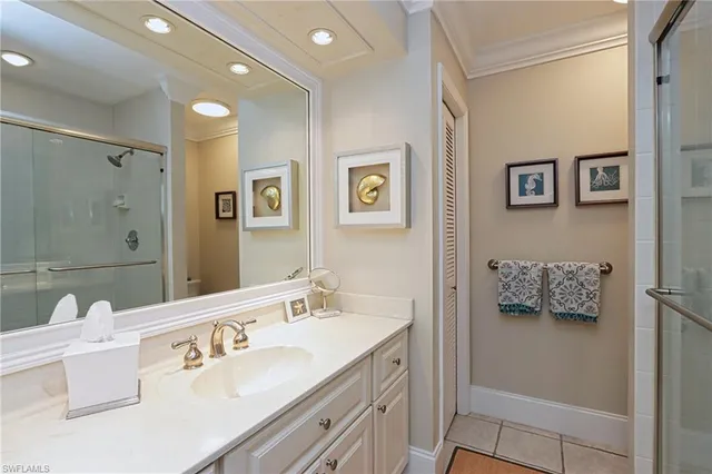 a bathroom with a double vanity sink mirror and bathtub