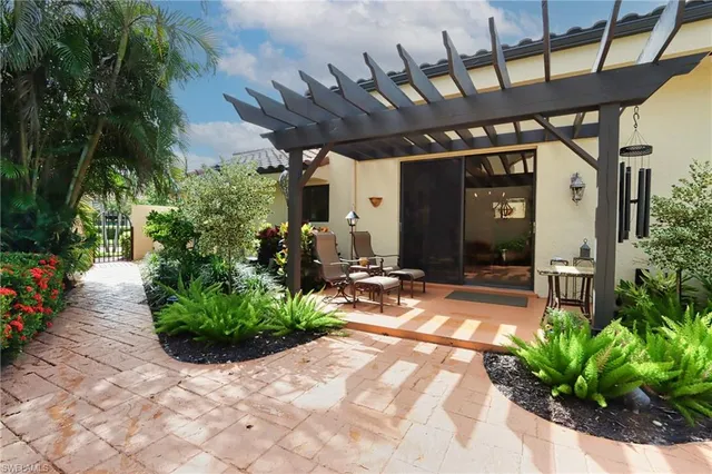 a view of a patio with table and chairs potted plants