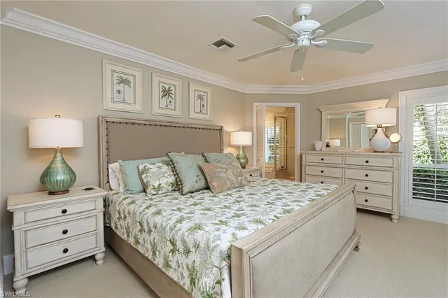a bedroom with a bed and ceiling fan