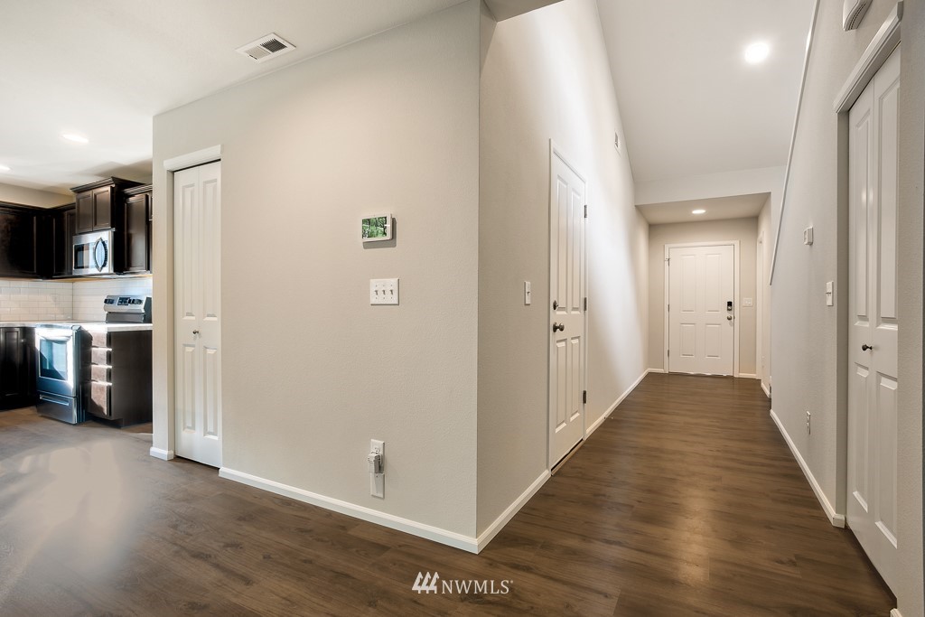 207 169th Place Southwest Bothell, WA 98012 - Photo 20 of 21 a view of a hallway with wooden floor and closet