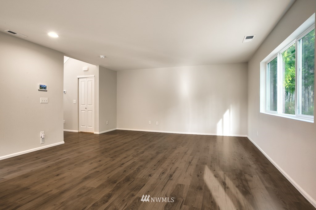 207 169th Place Southwest Bothell, WA 98012 - Photo 8 of 21 wooden floor in an empty room with a window