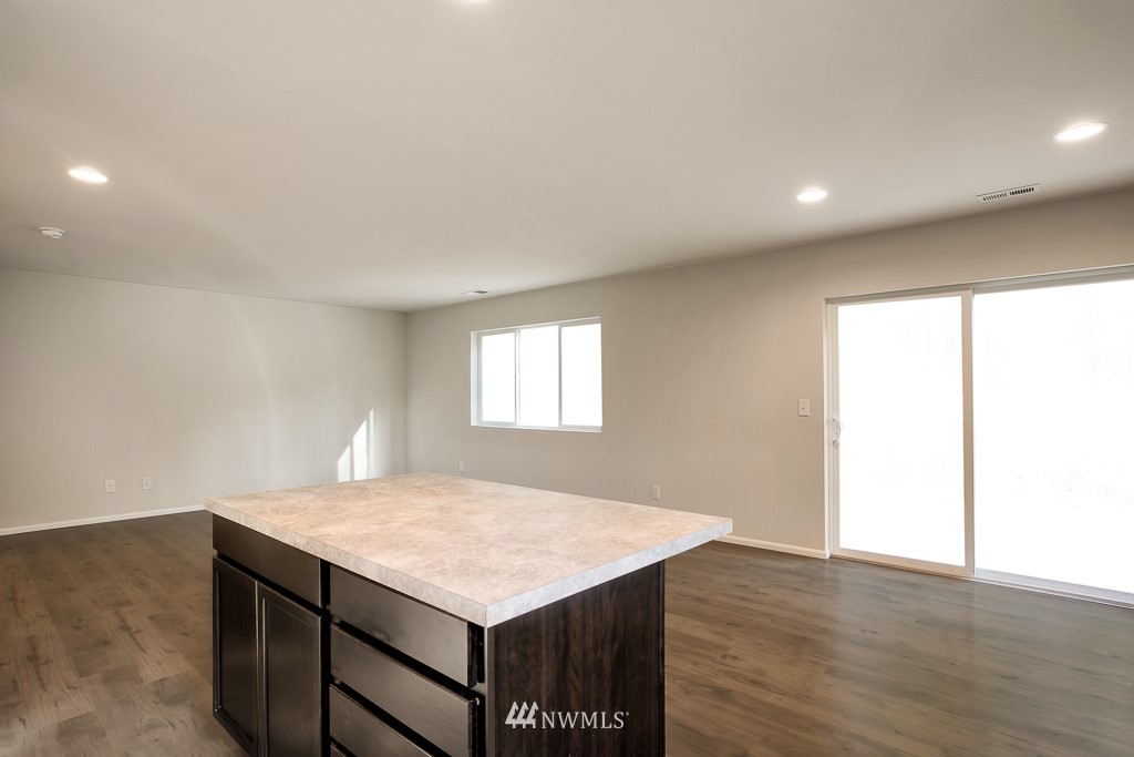 207 169th Place Southwest Bothell, WA 98012 - Photo 9 of 21 an empty room with a wooden floor