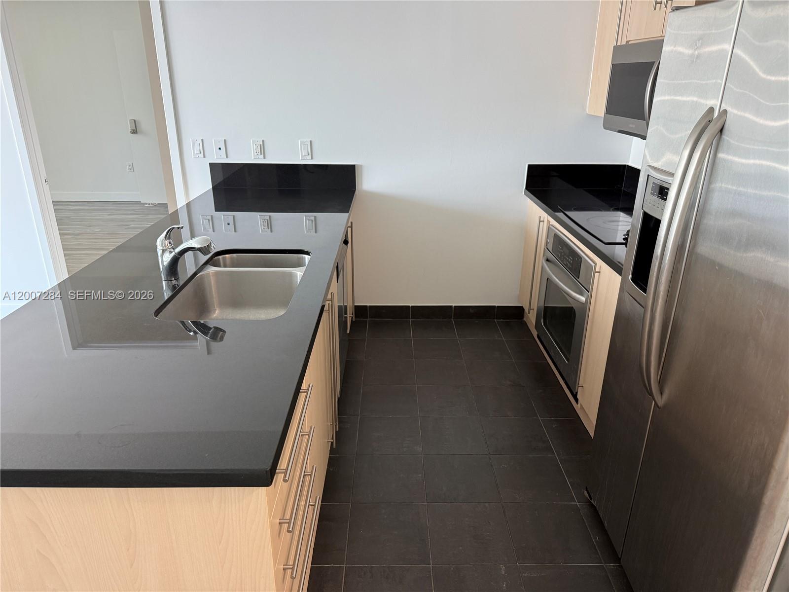 79 Southwest 12th Street, Unit 2509S Miami, FL 33130 - Photo 4 of 27 a bathroom with a sink and washing machine