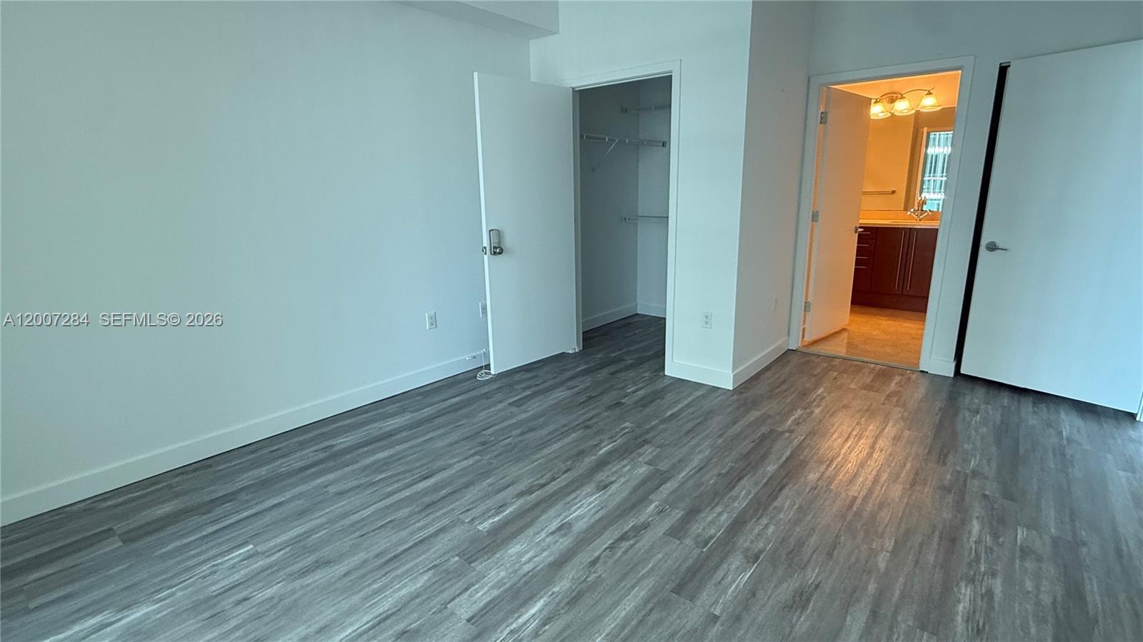 79 Southwest 12th Street, Unit 2509S Miami, FL 33130 - Photo 6 of 27 an empty room with wooden floor and closet