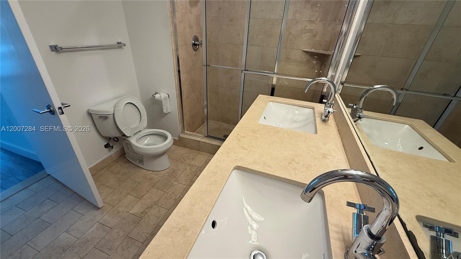 79 Southwest 12th Street, Unit 2509S Miami, FL 33130 - Photo 9 of 27 a bathroom with a sink and a mirror