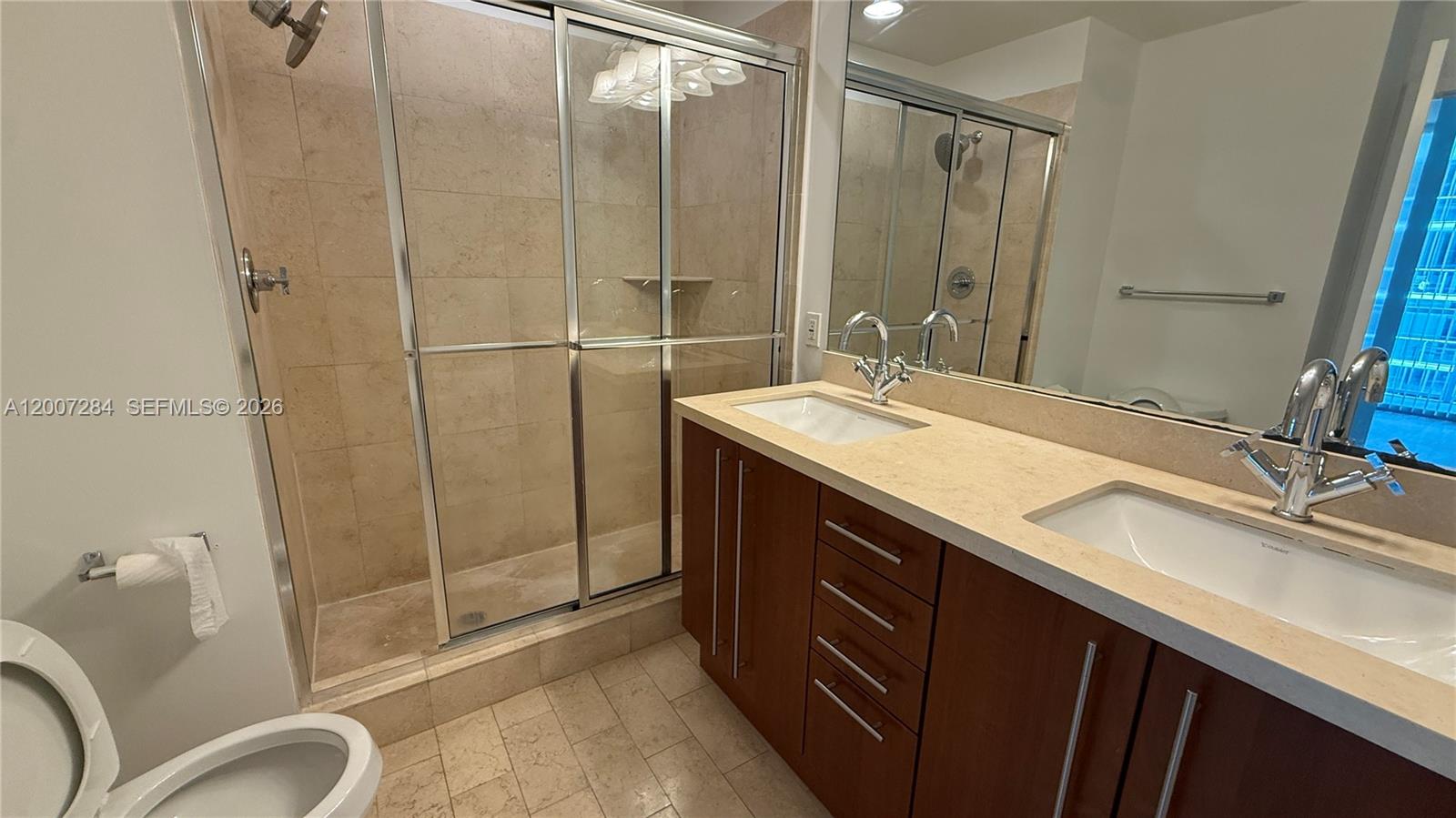 79 Southwest 12th Street, Unit 2509S Miami, FL 33130 - Photo 10 of 27 a bathroom with a double vanity sink toilet and shower