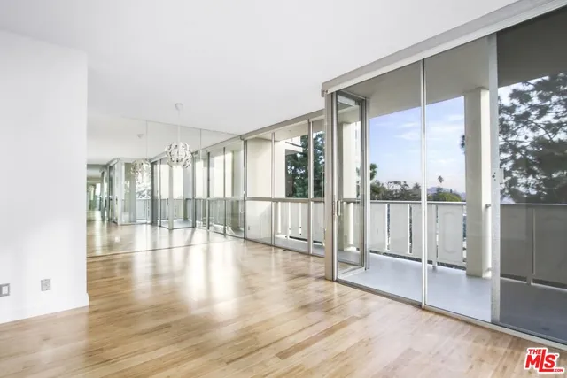 a view of a room with wooden floor