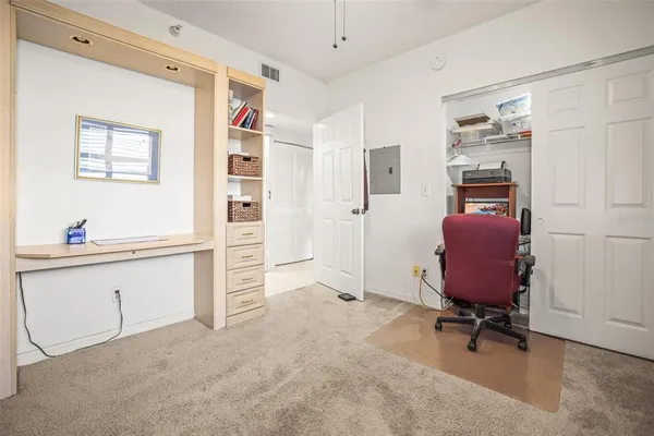 a spacious bedroom with two beds and a chandelier