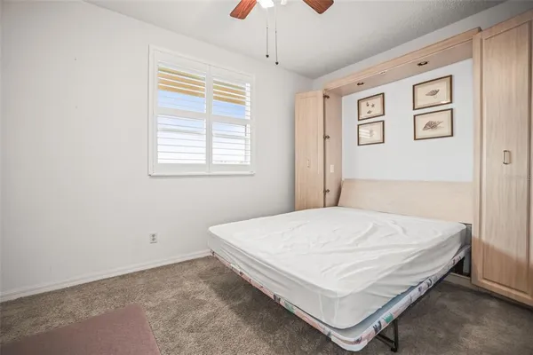 a bedroom with bed and window