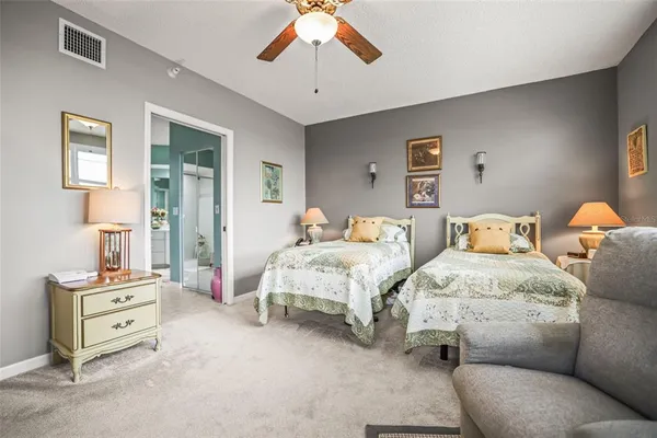 a bedroom with two beds and a chandelier