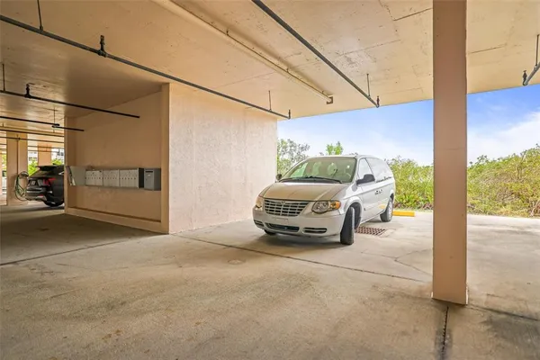 a front view of a building with a garden and plants