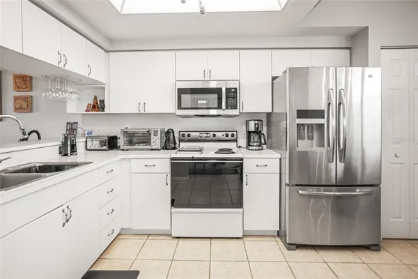 a kitchen with cabinets stainless steel appliances and a counter top space
