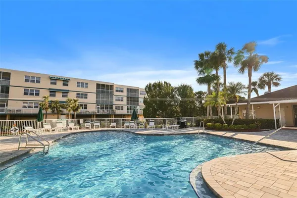 a view of a swimming pool with outdoor seating