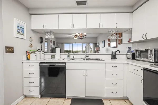 a kitchen with cabinets appliances and a counter space