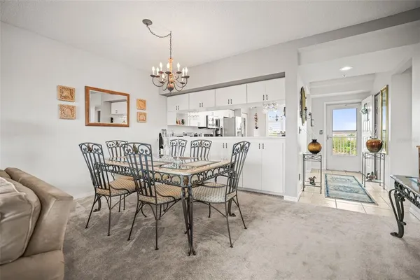 a view of a dining room with furniture and a chandelier