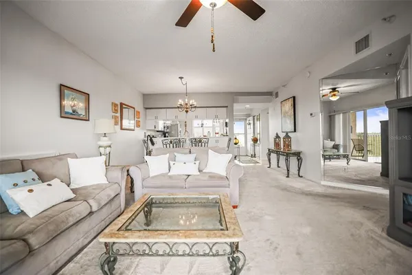 a living room with furniture and a chandelier