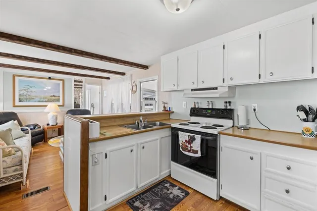 a kitchen with a sink stove and cabinets