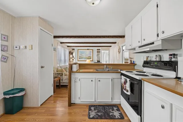 a kitchen with a sink and a stove top oven
