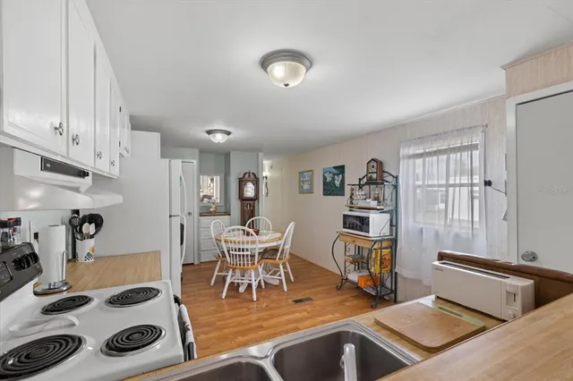 a living room with furniture cabinets and wooden floor