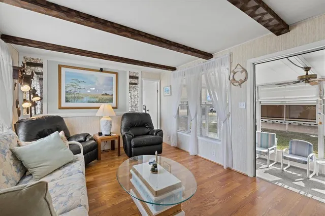 a living room with furniture a rug and wall painting