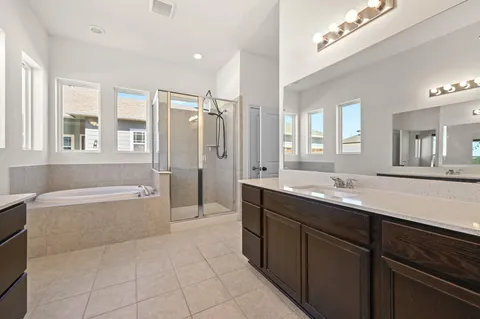 a view of an empty room with a window and a kitchen